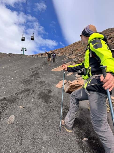 Catania: Mount Etna Adventurous Hiking Tour with Equipment - The Descent: Grotta Pitagora and the Volcanic Sand Dash