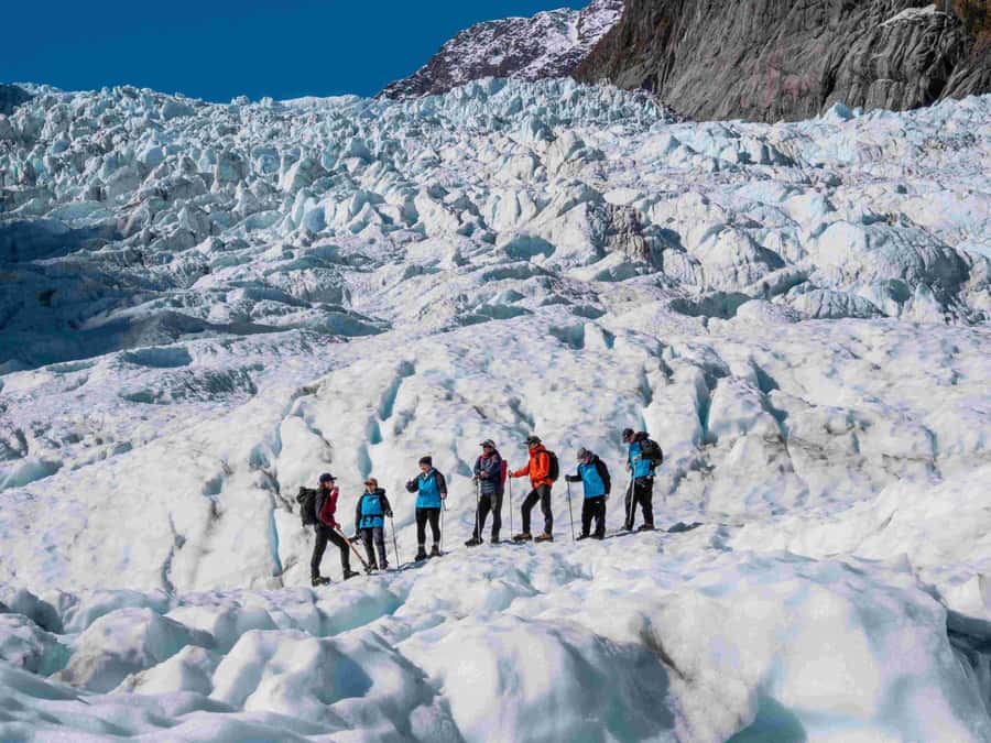 Fox Glacier: Up to 3 Hours Hike with Helicopter Transfer - Safety briefing, bus ride, and the first helicopter lift-off