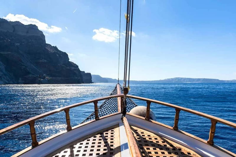 From Thera: Thirasia Cruise w/ Volcano Hike and Hot Springs - Sailing out of Athinios: caldera views with a built-in lesson