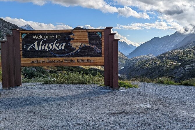 Yukon Husky Puppy Play Time & Summit Tour - White Pass summit stops: Alaska sign and Pitchfork Falls